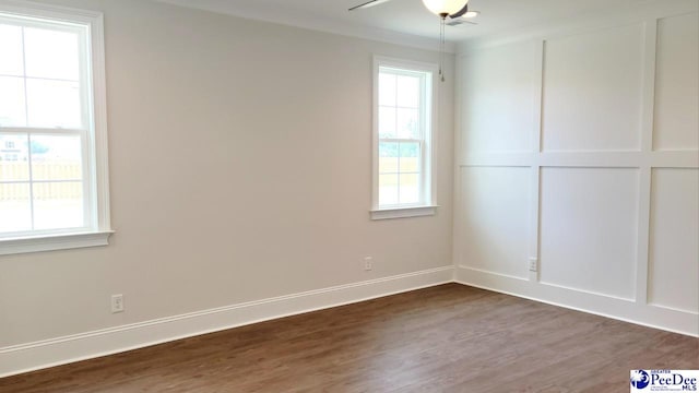 855 Bellemeade Cir, Florence, SC 29501 - empty room featuring dark wood finished floors, plenty of natural light, and a ceiling fan