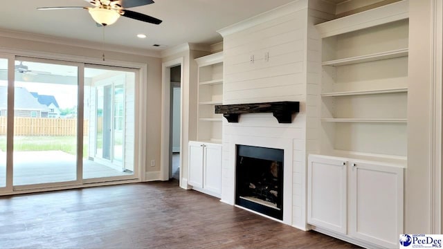 855 Bellemeade Cir, Florence, SC 29501 - unfurnished living room with a ceiling fan, ornamental molding, dark wood finished floors, built in features, and a fireplace