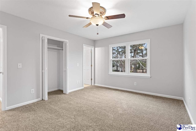 unfurnished bedroom with a closet, ceiling fan, and carpet