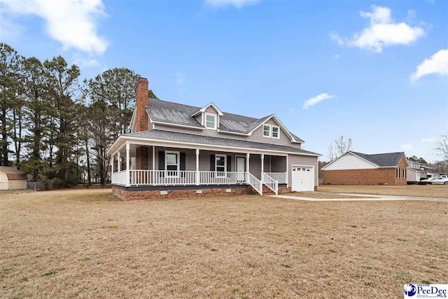 view of front of home featuring a porch, a garage, and a front yard