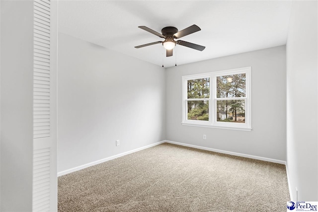 spare room with ceiling fan and carpet flooring