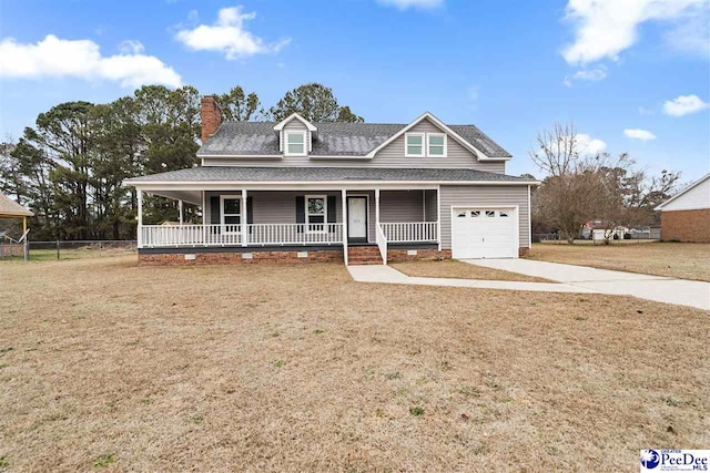 view of front of home with a garage, a front lawn, and covered porch