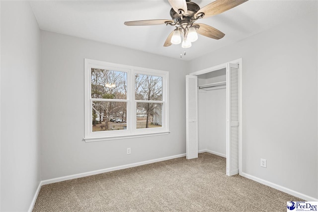 unfurnished bedroom featuring ceiling fan, carpet floors, and a closet