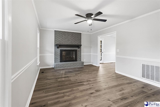 unfurnished living room with crown molding, a fireplace, dark hardwood / wood-style floors, and ceiling fan