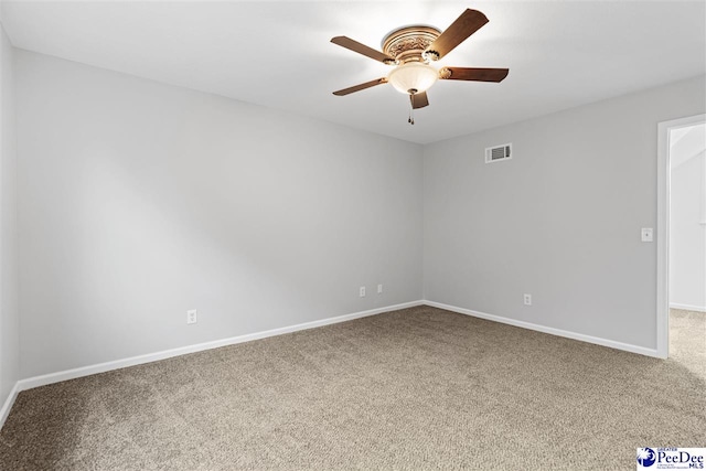 carpeted spare room featuring ceiling fan