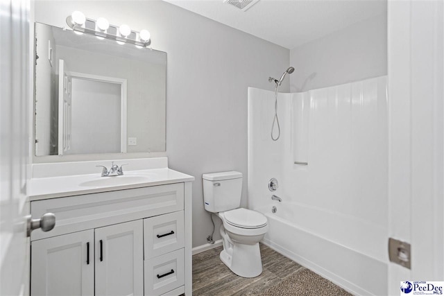 full bathroom with shower / bathtub combination, vanity, toilet, and hardwood / wood-style floors