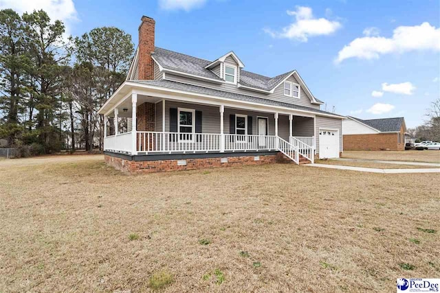 farmhouse with a garage, covered porch, and a front lawn