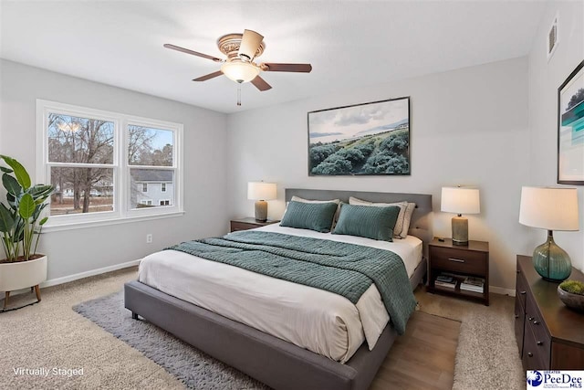 bedroom featuring light colored carpet and ceiling fan