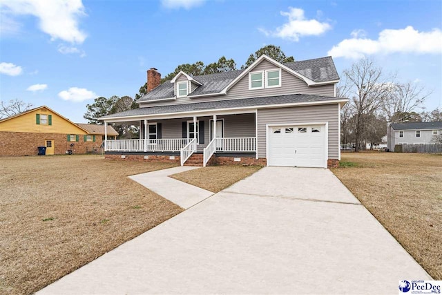 view of front of house featuring a porch, a garage, and a front yard