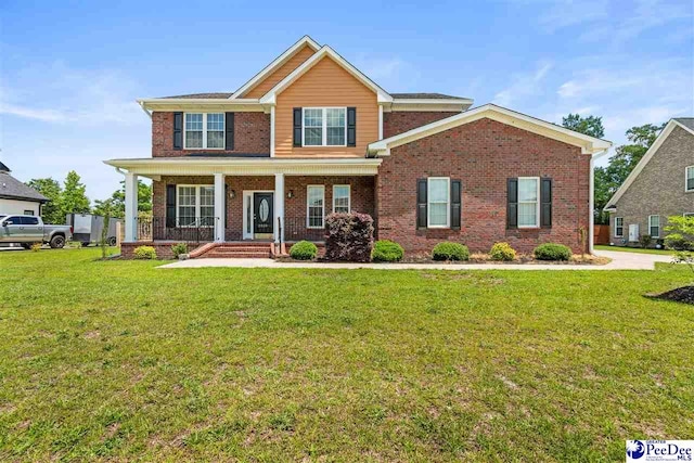 view of front of property with covered porch and a front yard