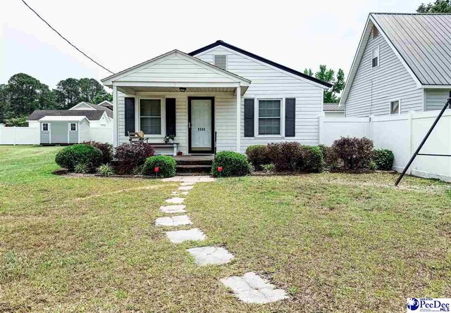 2526 Lester Rd, Dillon, SC 29536 - view of front of property featuring covered porch, a storage shed, and an outdoor structure