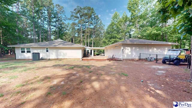 1103 Pine Lake Dr, Hartsville, SC 29550 - back of property with cooling unit and view of scattered trees