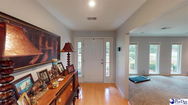 1103 Pine Lake Dr, Hartsville, SC 29550 - foyer featuring baseboards, light wood-type flooring, and light colored carpet