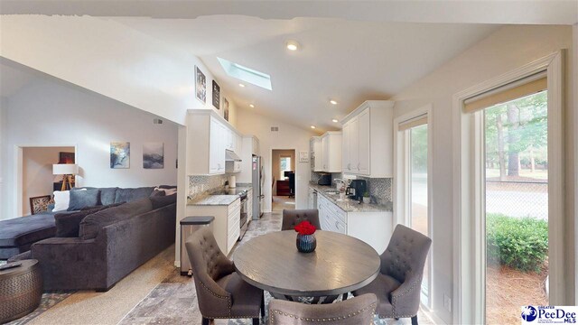 1103 Pine Lake Dr, Hartsville, SC 29550 - dining space with lofted ceiling, a skylight, and recessed lighting
