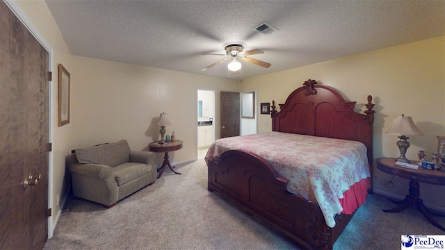 1103 Pine Lake Dr, Hartsville, SC 29550 - carpeted bedroom with connected bathroom, a ceiling fan, and a textured ceiling