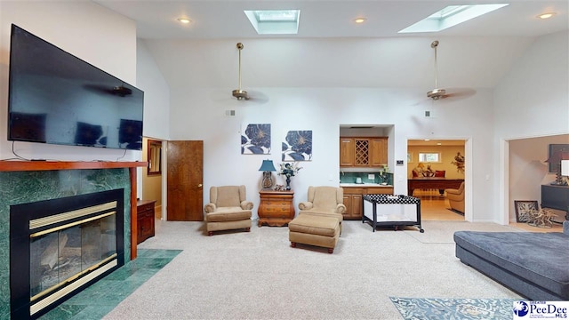 1103 Pine Lake Dr, Hartsville, SC 29550 - living room with a skylight, high vaulted ceiling, a tiled fireplace, light colored carpet, and a ceiling fan