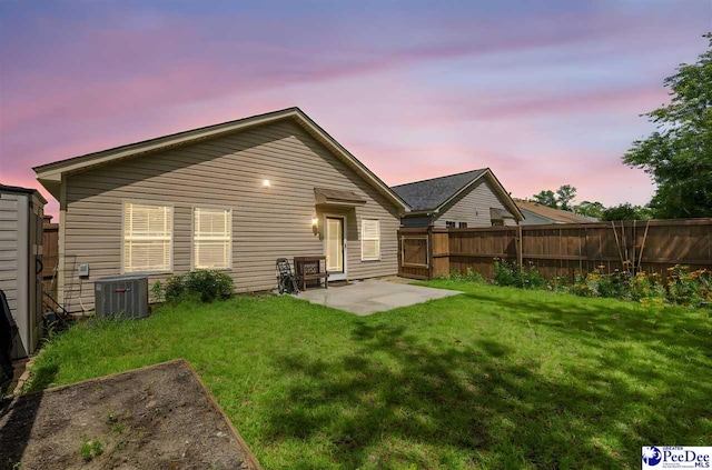 2141 Harbour Ln, Florence, SC 29505 - back of house at dusk with a fenced backyard and a patio area
