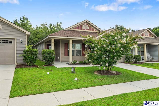 2141 Harbour Ln, Florence, SC 29505 - view of front facade with concrete driveway, covered porch, a front lawn, and an attached garage