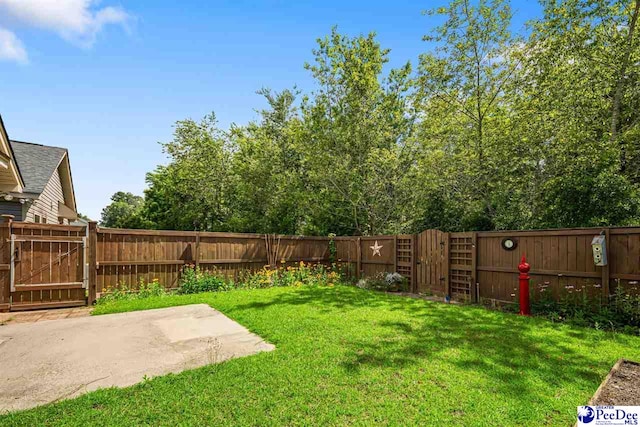 2141 Harbour Ln, Florence, SC 29505 - fenced backyard featuring a gate and a patio area
