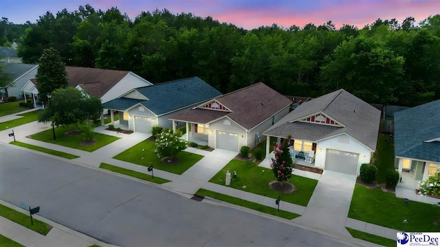 2141 Harbour Ln, Florence, SC 29505 - view of front facade featuring driveway, a front yard, an attached garage, covered porch, and a residential view
