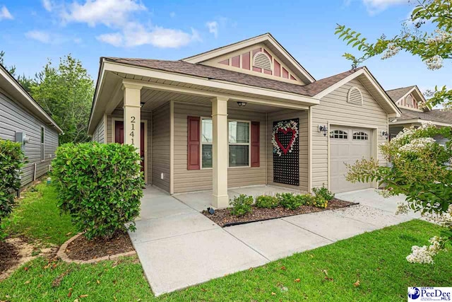 2141 Harbour Ln, Florence, SC 29505 - view of front facade with a porch, an attached garage, and board and batten siding