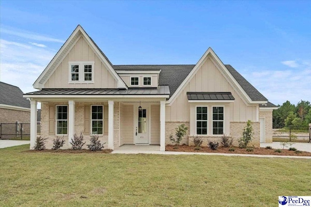 view of front of house with a porch and a front lawn