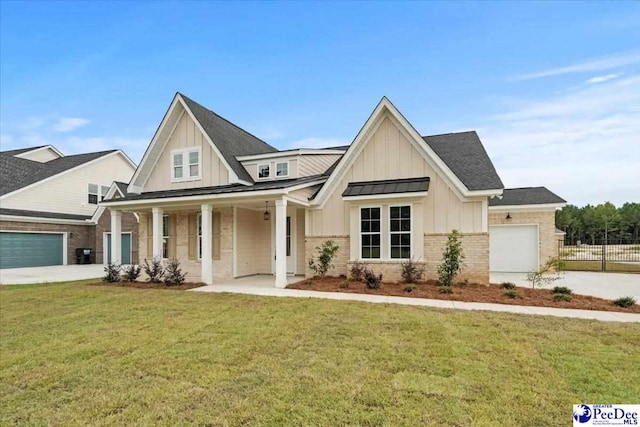 view of front of home featuring a garage, covered porch, and a front lawn