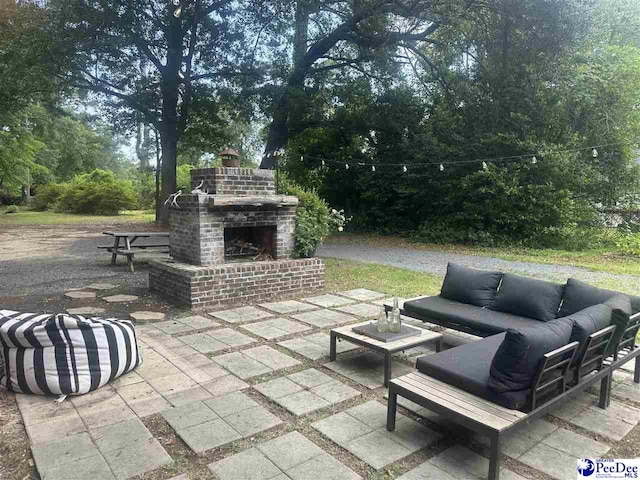 412 W Greene St, Cheraw, SC 29520 - view of patio / terrace featuring an outdoor living space with a fireplace and view of wooded area