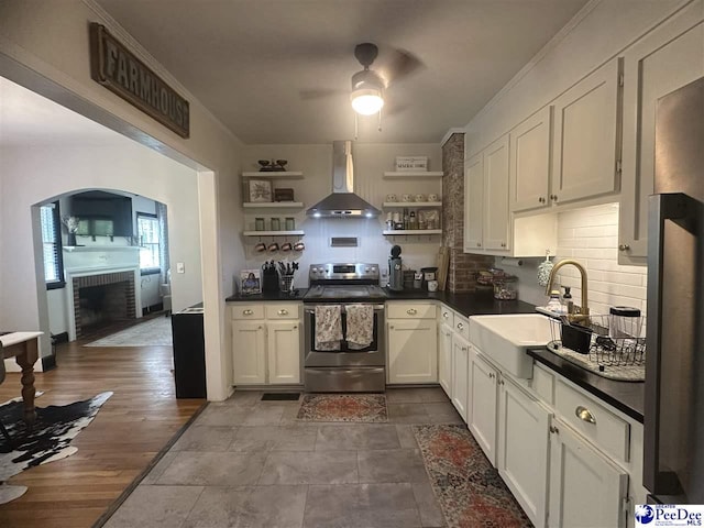 412 W Greene St, Cheraw, SC 29520 - kitchen with wall chimney exhaust hood, electric range, open shelves, ceiling fan, and dark countertops