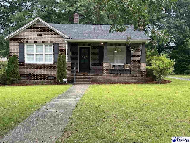 412 W Greene St, Cheraw, SC 29520 - view of front of property featuring brick siding, covered porch, a front yard, and a chimney