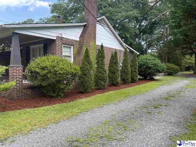 412 W Greene St, Cheraw, SC 29520 - view of home's exterior featuring brick siding and a chimney