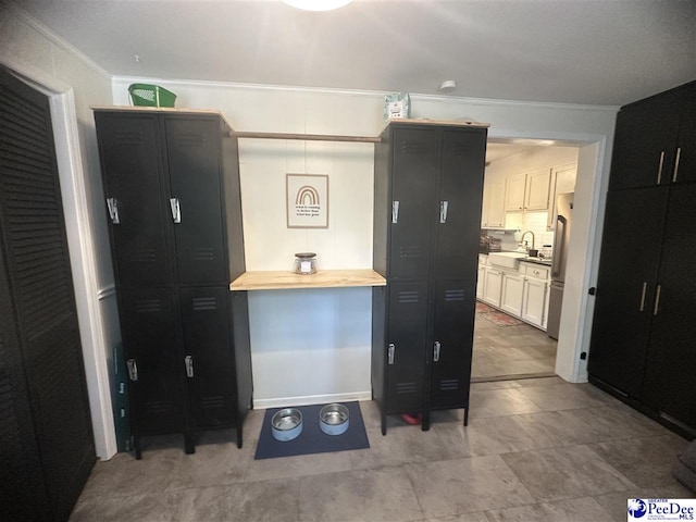 412 W Greene St, Cheraw, SC 29520 - kitchen with ornamental molding, freestanding refrigerator, butcher block counters, decorative backsplash, and white cabinets