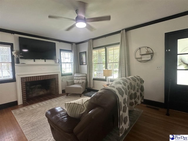 412 W Greene St, Cheraw, SC 29520 - living room with ornamental molding, wood finished floors, a ceiling fan, and a fireplace