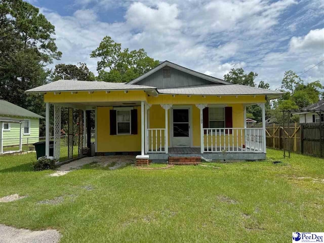 bungalow-style house with a front lawn and covered porch