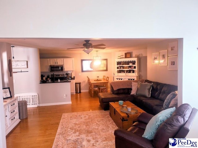 2109UNITG Sanderling, Florence, SC 29501 - living area featuring light wood-type flooring, ceiling fan, and baseboards
