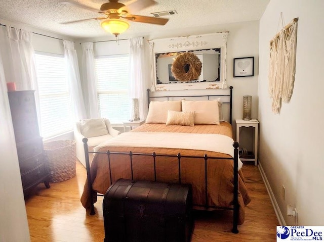 2109UNITG Sanderling, Florence, SC 29501 - bedroom featuring wood finished floors, a textured ceiling, ceiling fan, and baseboards