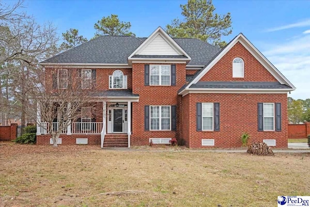 view of front of home featuring crawl space, brick siding, roof with shingles, and a front yard