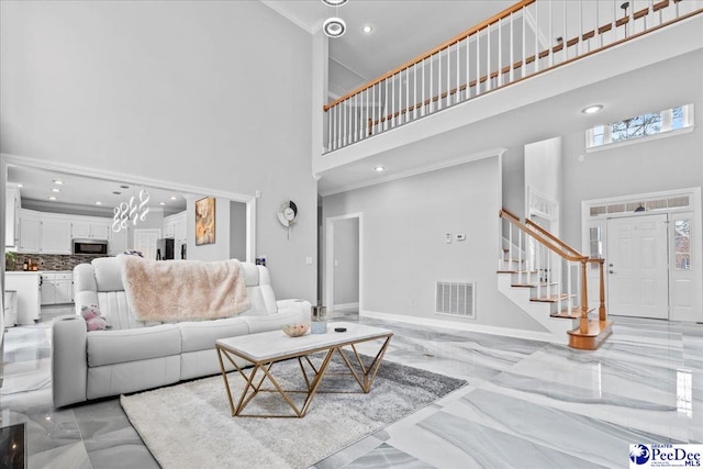 living area with visible vents, a high ceiling, marble finish floor, and stairs