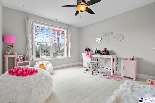 bedroom with visible vents, ceiling fan, baseboards, and wood finished floors