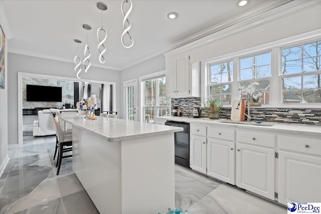 kitchen with marble finish floor, ornamental molding, a sink, light stone counters, and black dishwasher