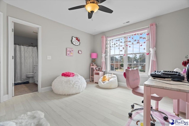 office featuring visible vents, baseboards, wood finished floors, and a ceiling fan