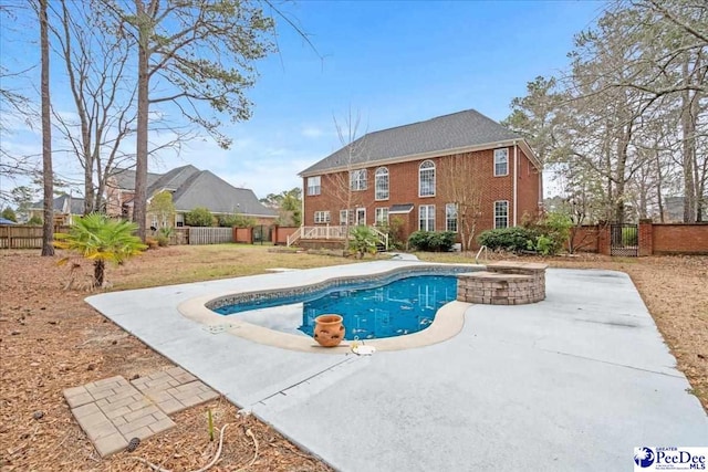 view of swimming pool featuring a wooden deck, a fenced in pool, and fence