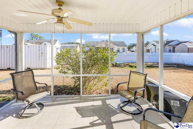 sunroom / solarium with wooden ceiling and a ceiling fan