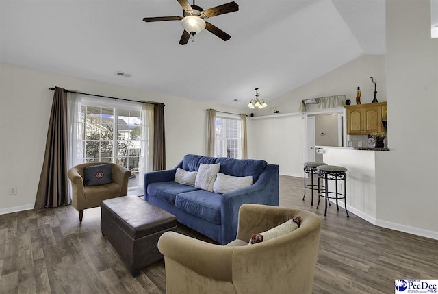 living room with dark wood-style floors, visible vents, vaulted ceiling, baseboards, and ceiling fan with notable chandelier