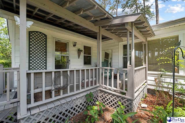view of exterior entry with covered porch