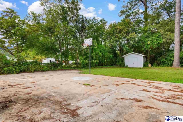 view of patio / terrace with basketball court and a storage unit