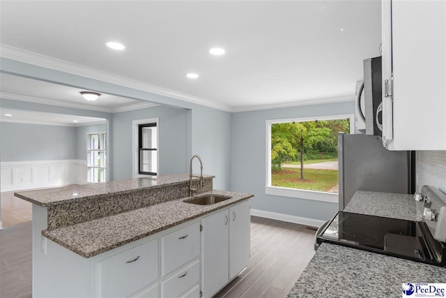 kitchen featuring appliances with stainless steel finishes, sink, and white cabinets