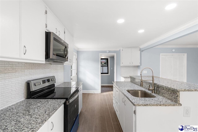 kitchen with sink, crown molding, appliances with stainless steel finishes, white cabinetry, and light stone counters