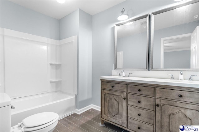 full bathroom featuring vanity, wood-type flooring, shower / bathtub combination, and toilet