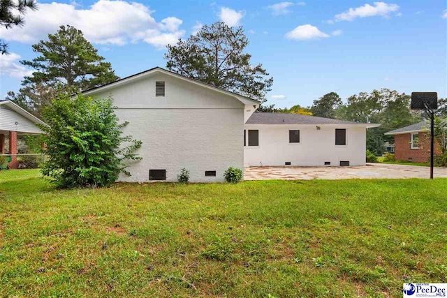 back of property with a patio area and a lawn